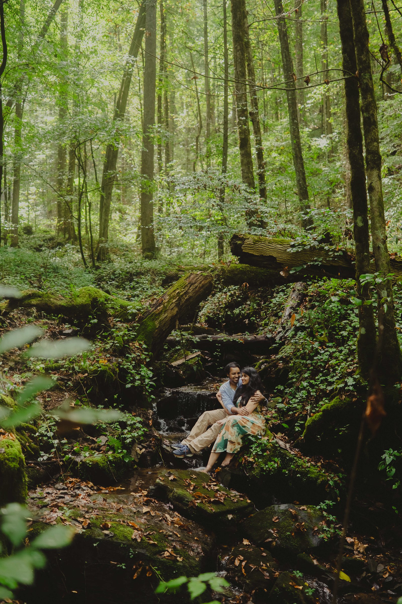 James and Srinidhi sharing a quiet moment in a forest